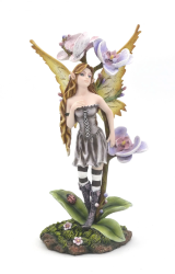 Jolie figurine de fée entourée de fleurs d'orchidées